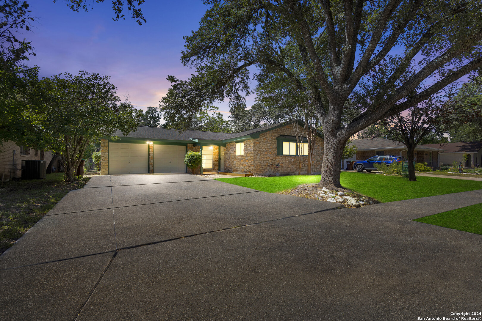 a front view of house with yard and green space