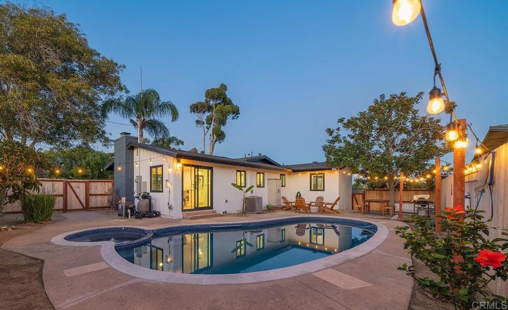 a view of swimming pool with outdoor seating and plants