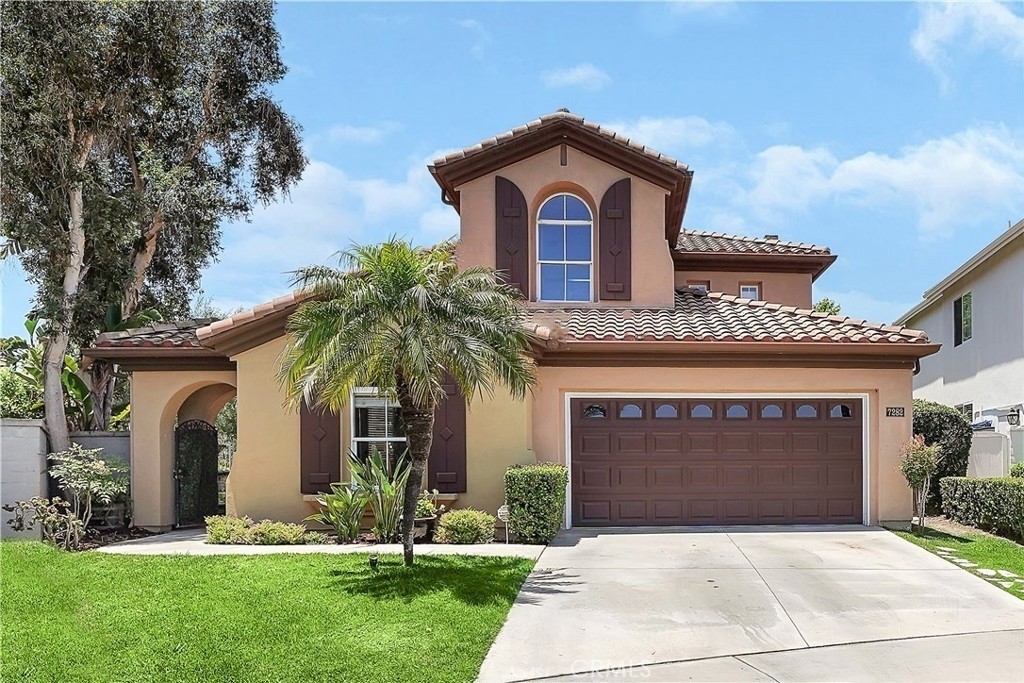 a front view of a house with a yard and garage