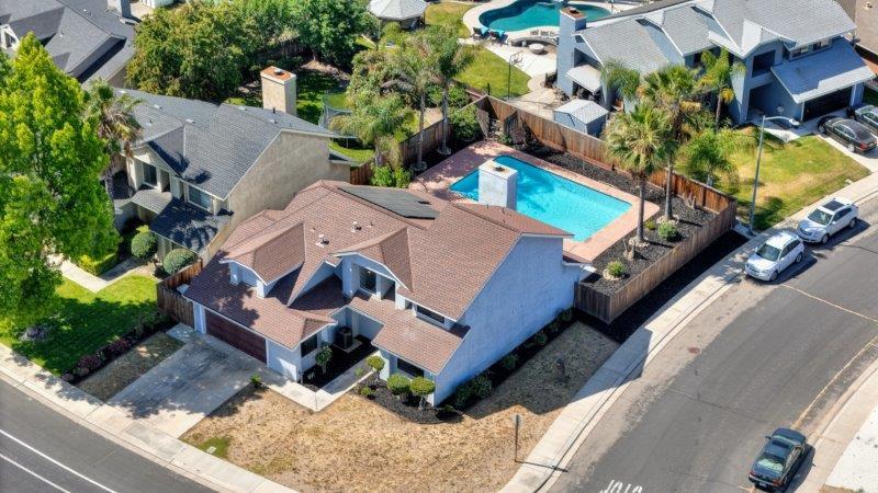 an aerial view of a house with a yard and sitting area