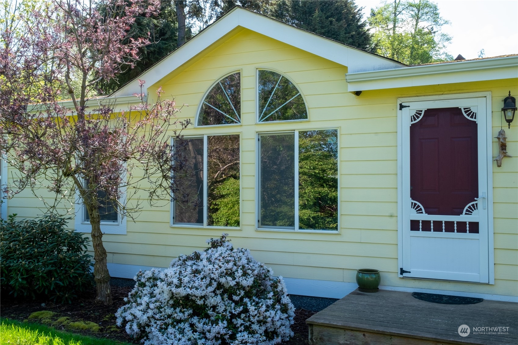 a view of a house with a yard and sitting area