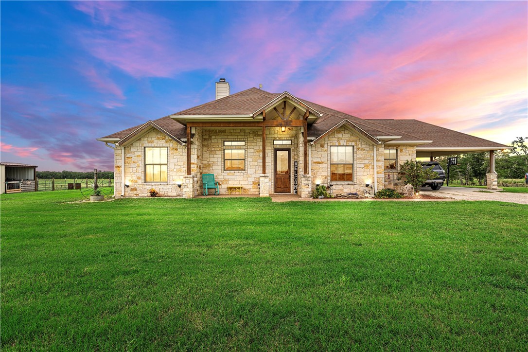 a front view of a house with a garden