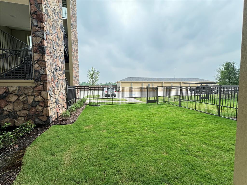 a view of a big yard with a big and trees