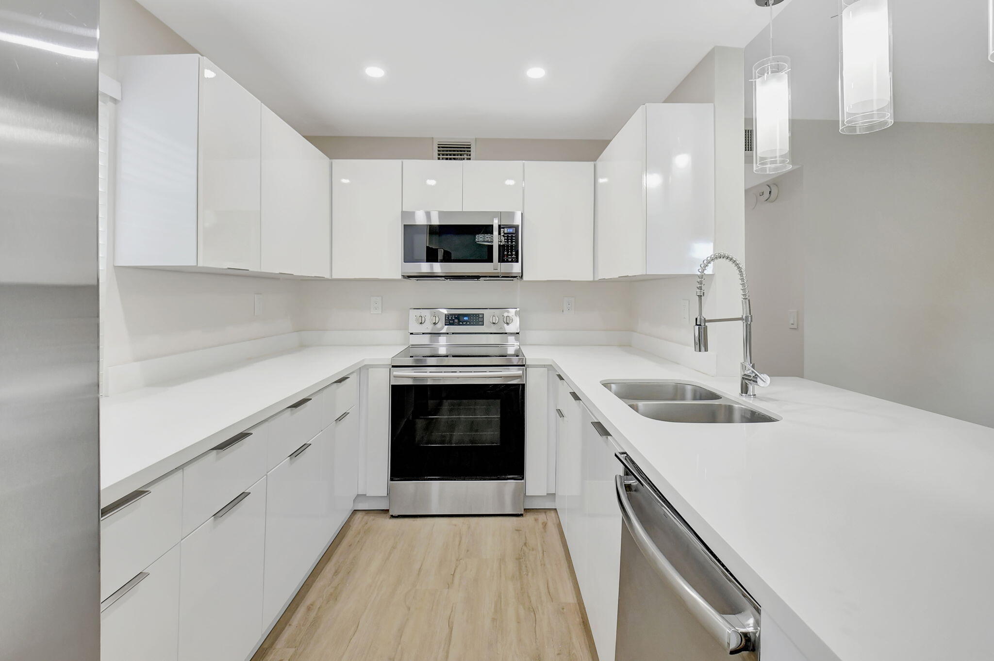 a kitchen with a sink stove and cabinets