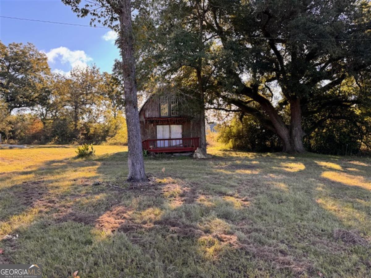 a view of outdoor space with deck and tree