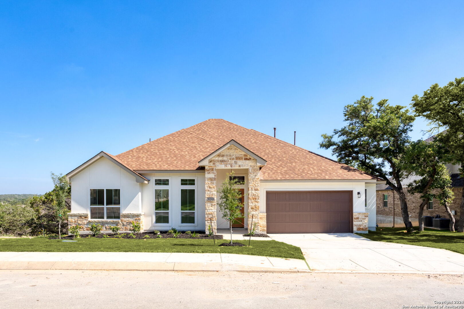 a front view of a house with a garden