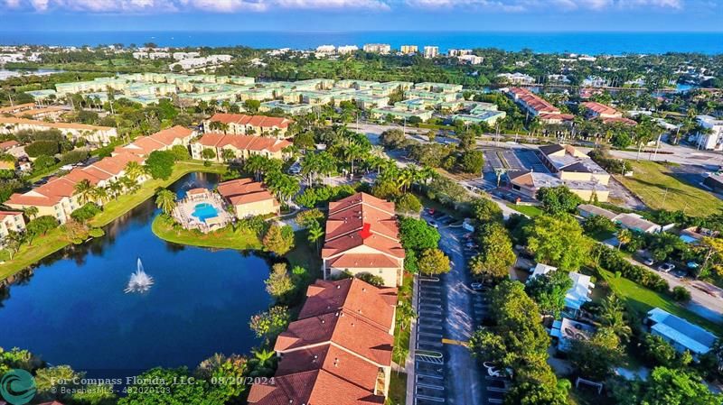 an aerial view of residential houses with outdoor space and swimming pool