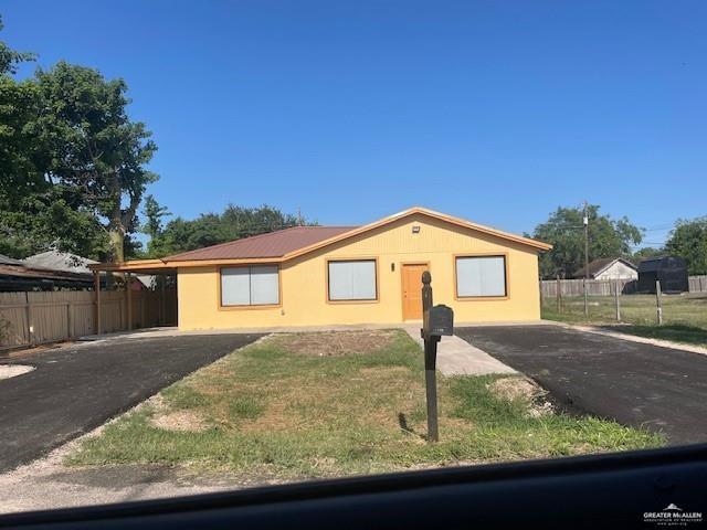 Single story home featuring a front lawn