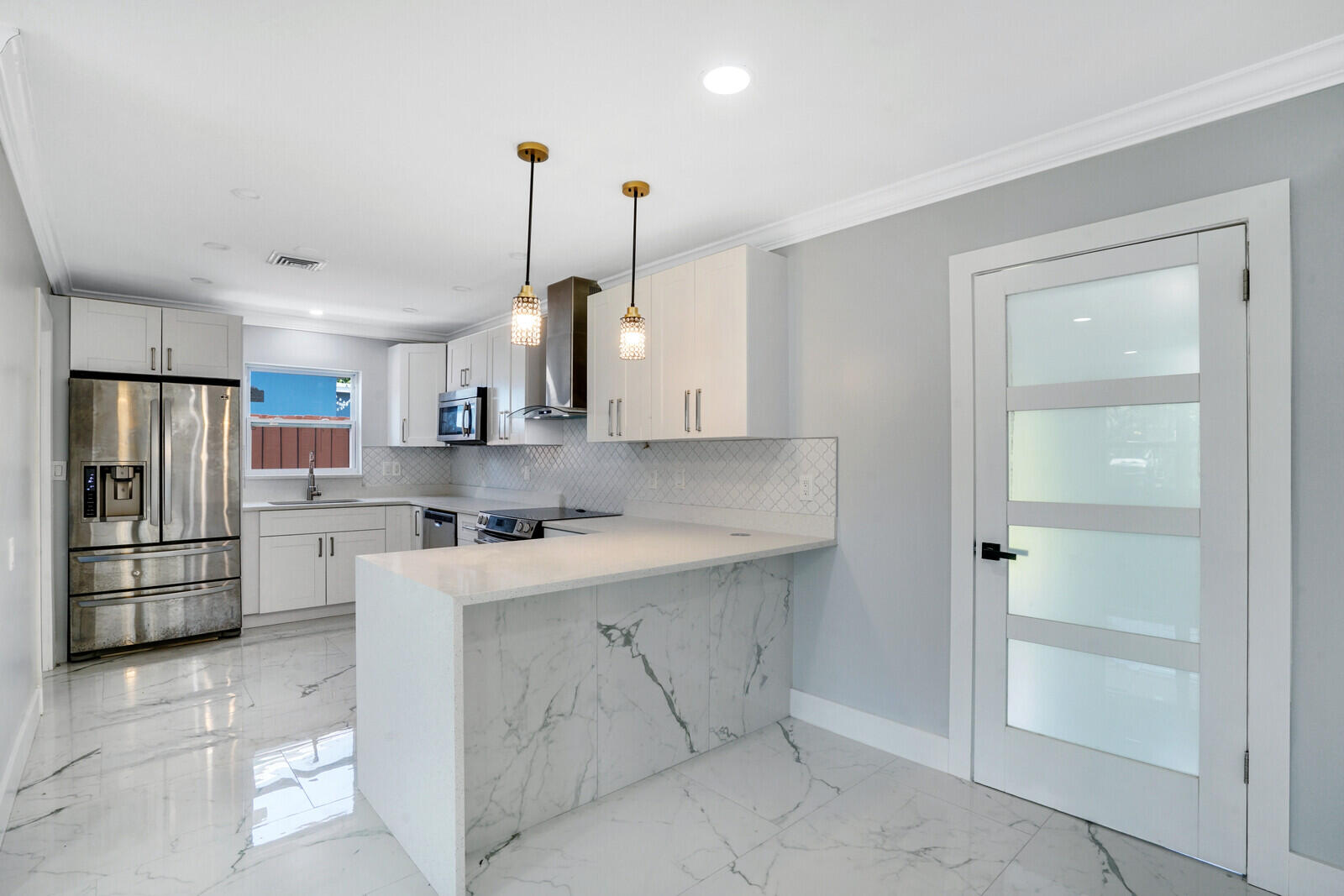 a kitchen with stainless steel appliances a sink stove and refrigerator