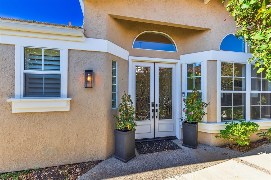 a view of a house with potted plants