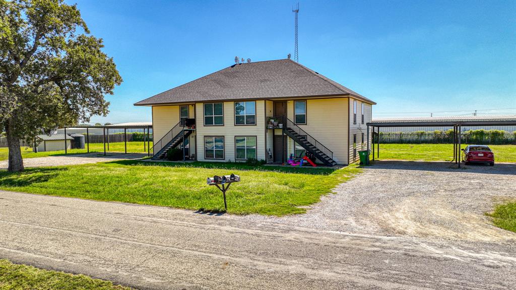 a view of a house with a yard and sitting area