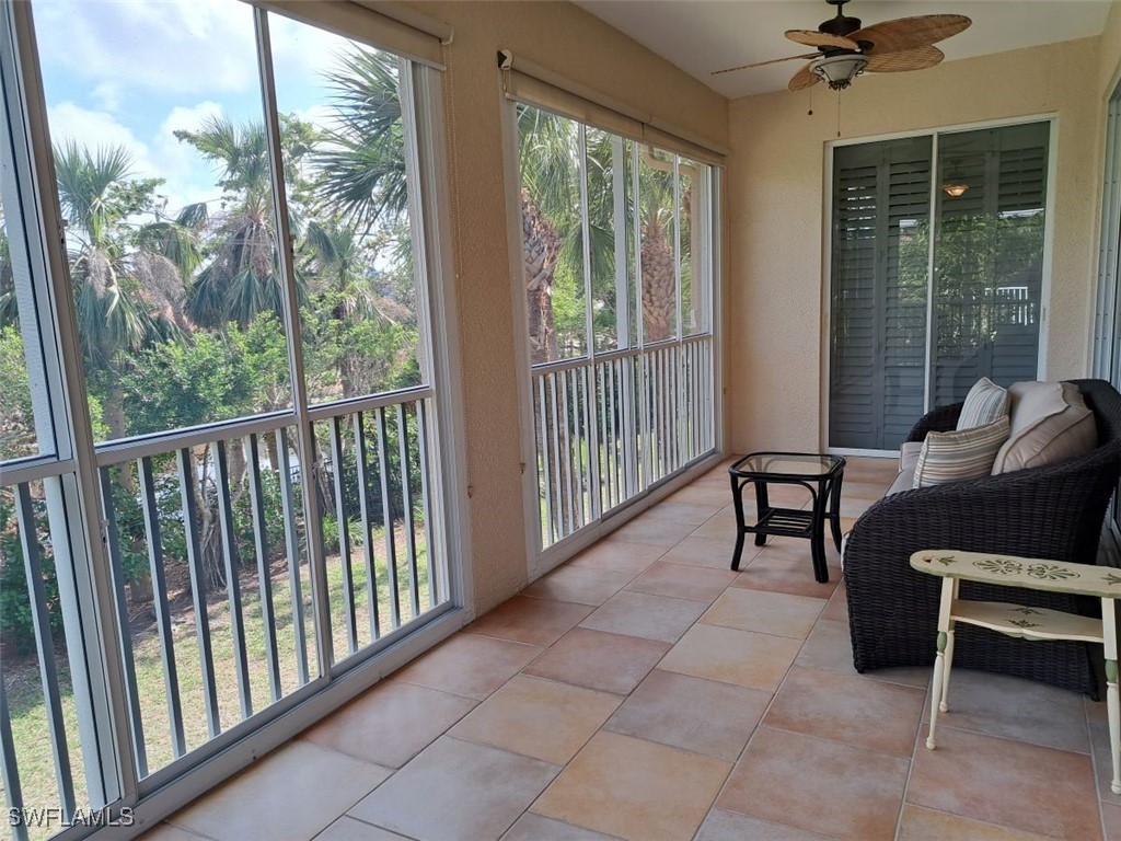 a view of a porch with chairs and a yard