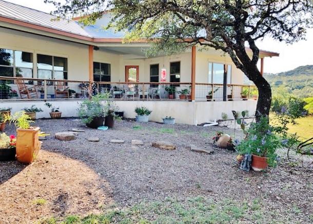 a view of a house with backyard and sitting area