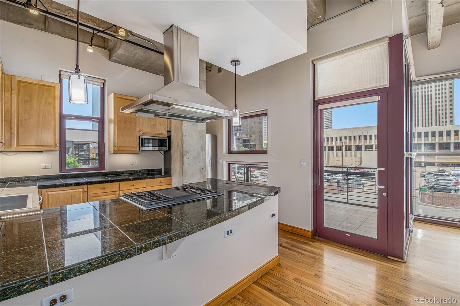 a kitchen with stainless steel appliances granite countertop a sink and a refrigerator