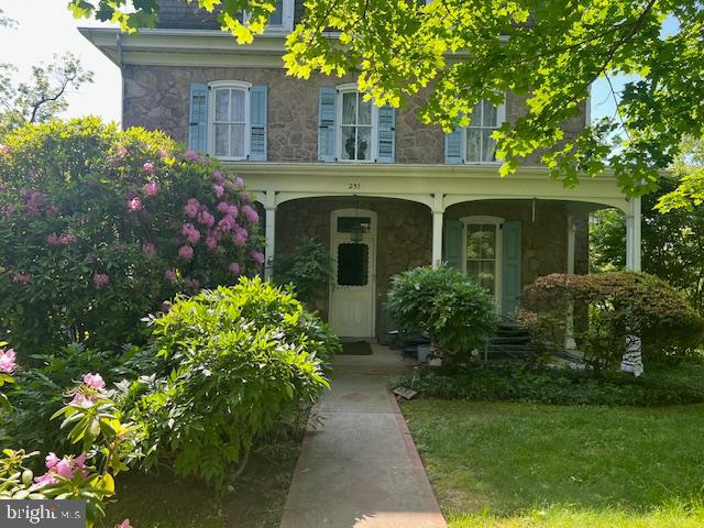 a front view of a house with plants