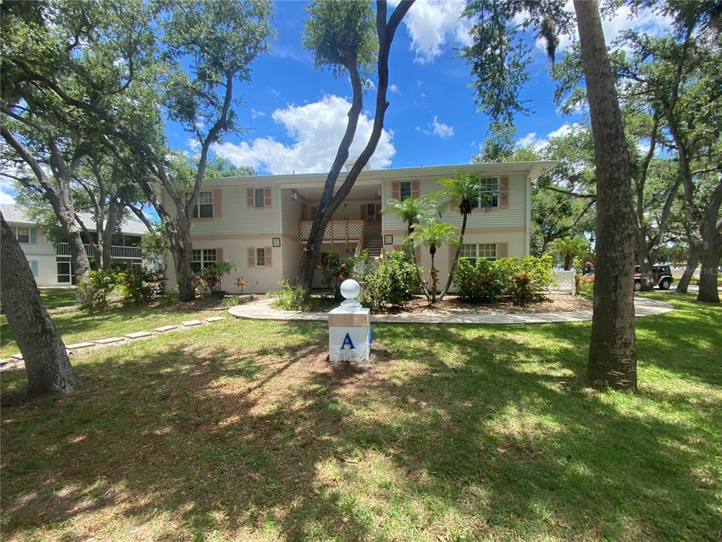 a view of a house with a yard porch and sitting area