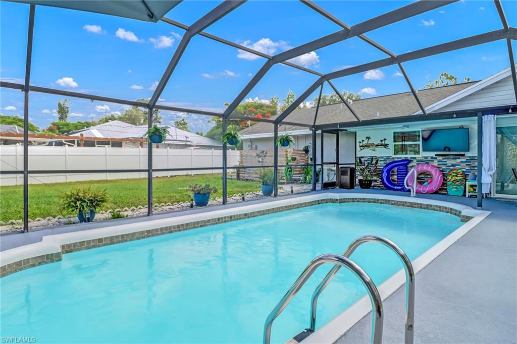 View of pool featuring glass enclosure