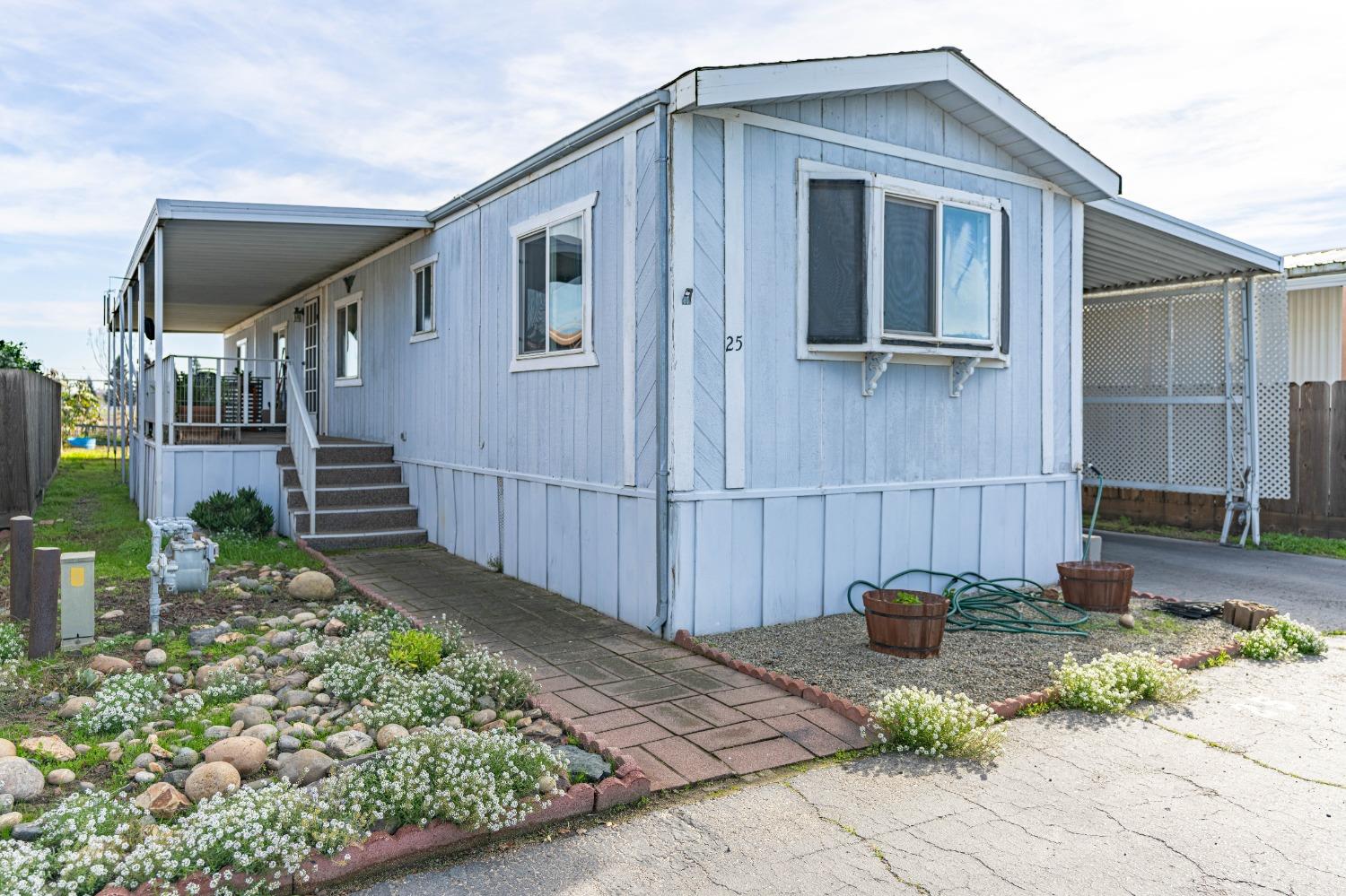 a view of a house with backyard and sitting area