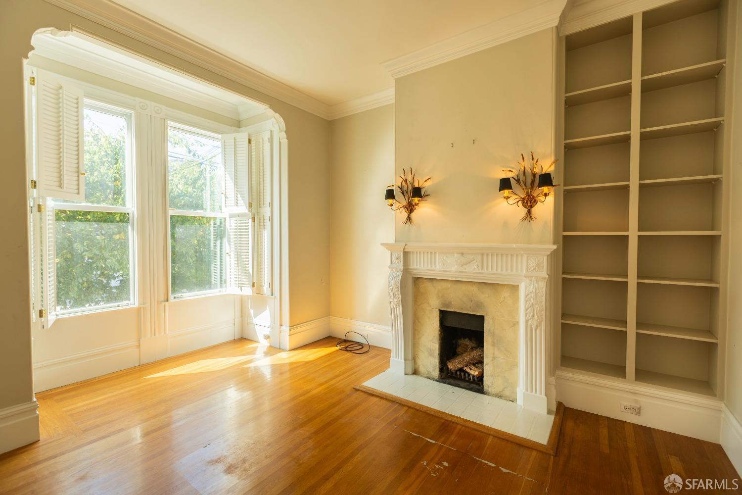 a view of a livingroom with a fireplace and window