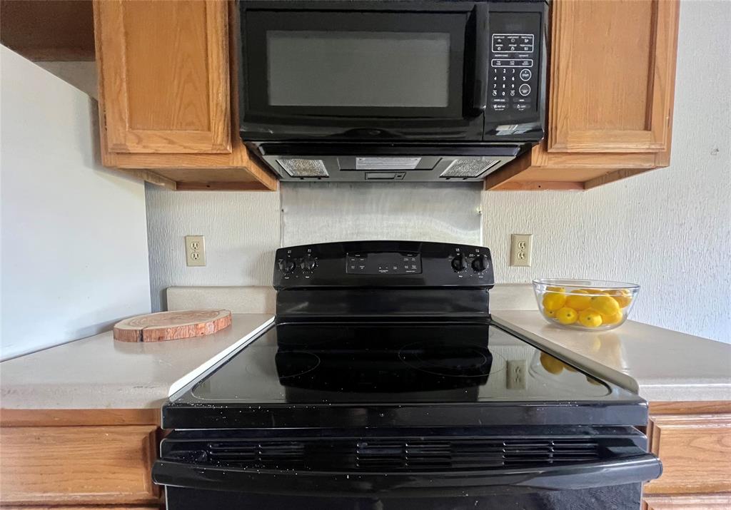 a stove top oven sitting inside of a kitchen