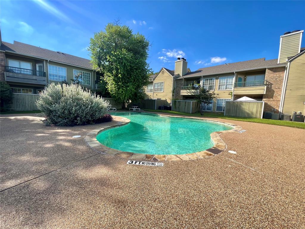 a view of a house with a swimming pool and a yard