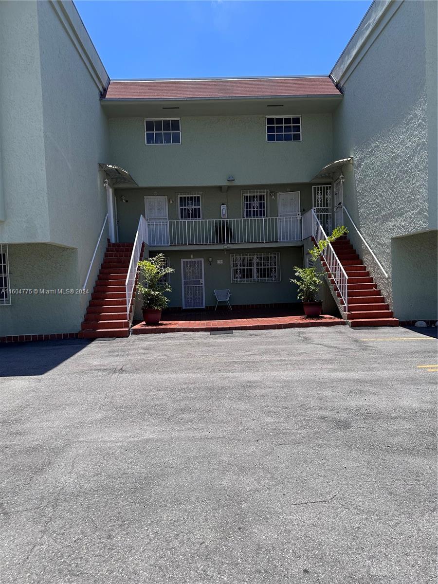 a view of front door of house with stairs