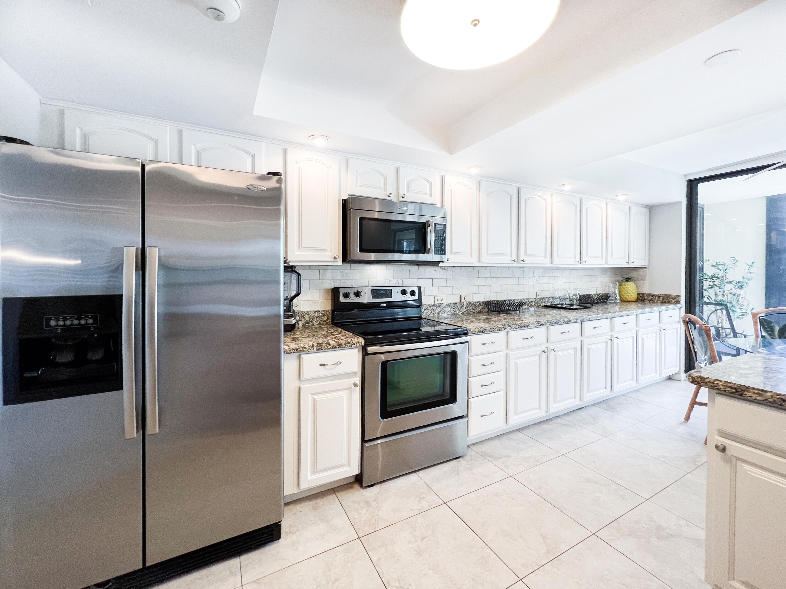 a kitchen with a refrigerator stove and microwave