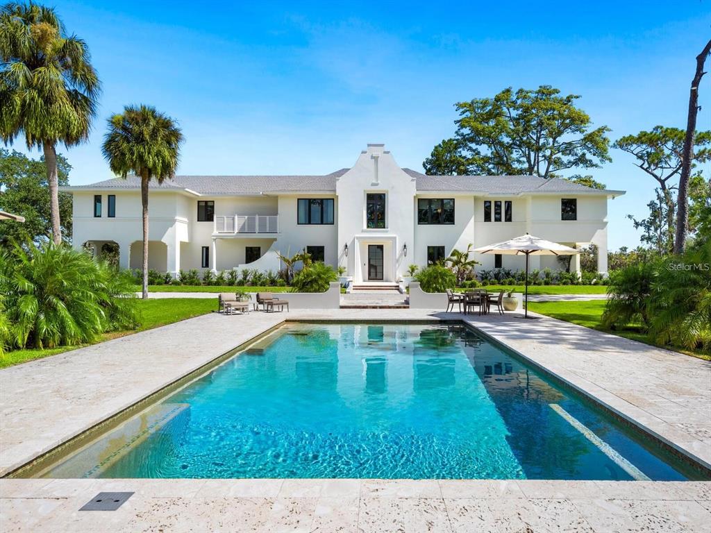 a swimming pool view with a outdoor seating