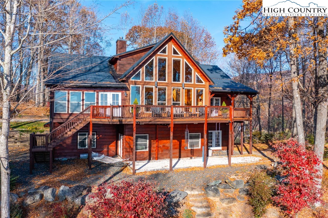 a view of a house with a yard patio and furniture