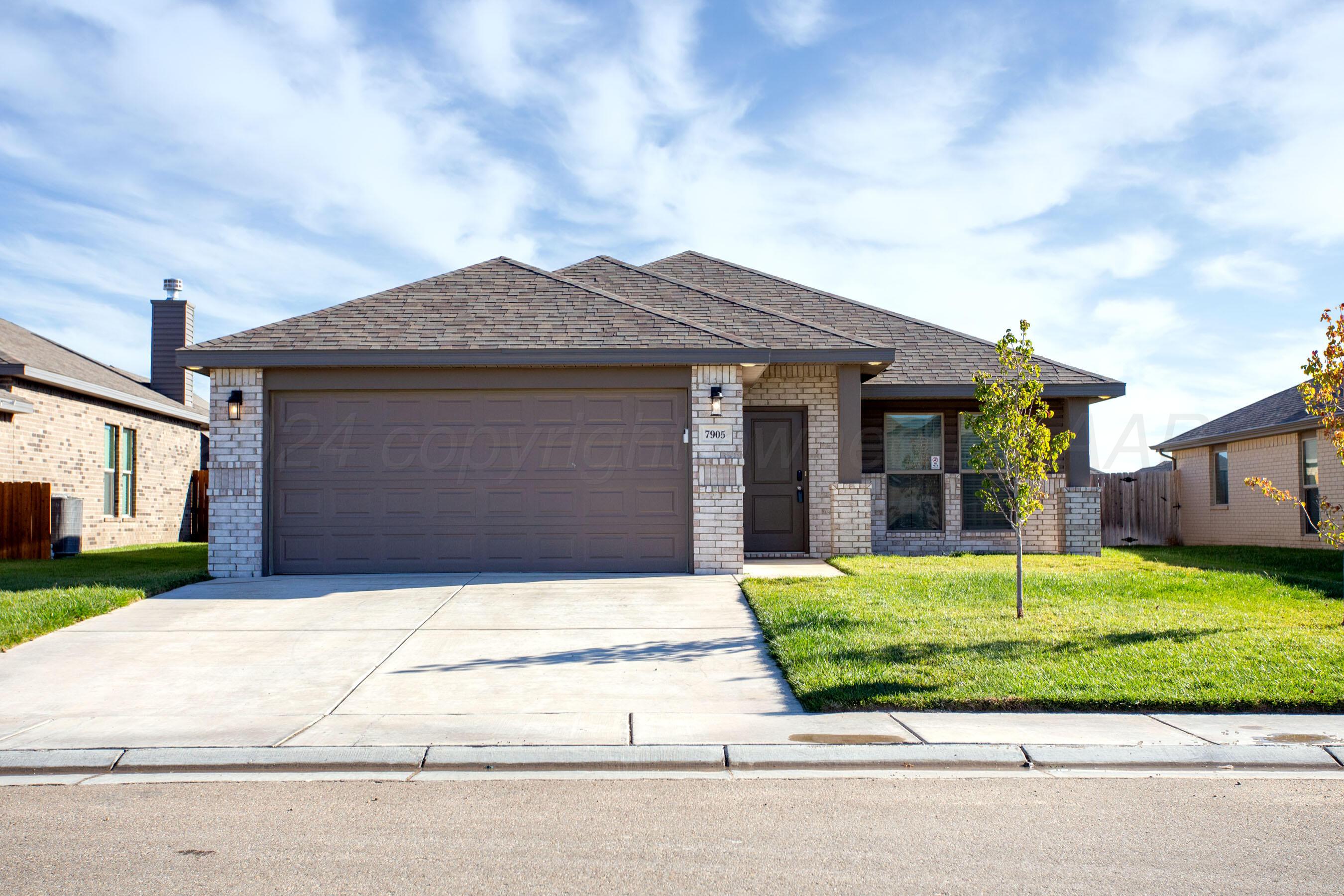 a front view of a house with a yard garage and garage