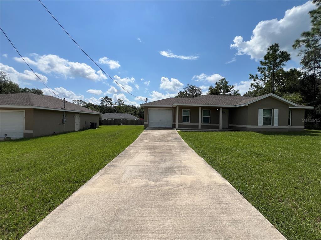 a front view of house with a garden