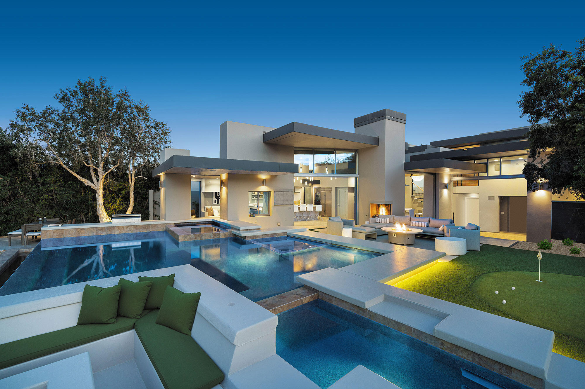 a view of a house with swimming pool and sitting area