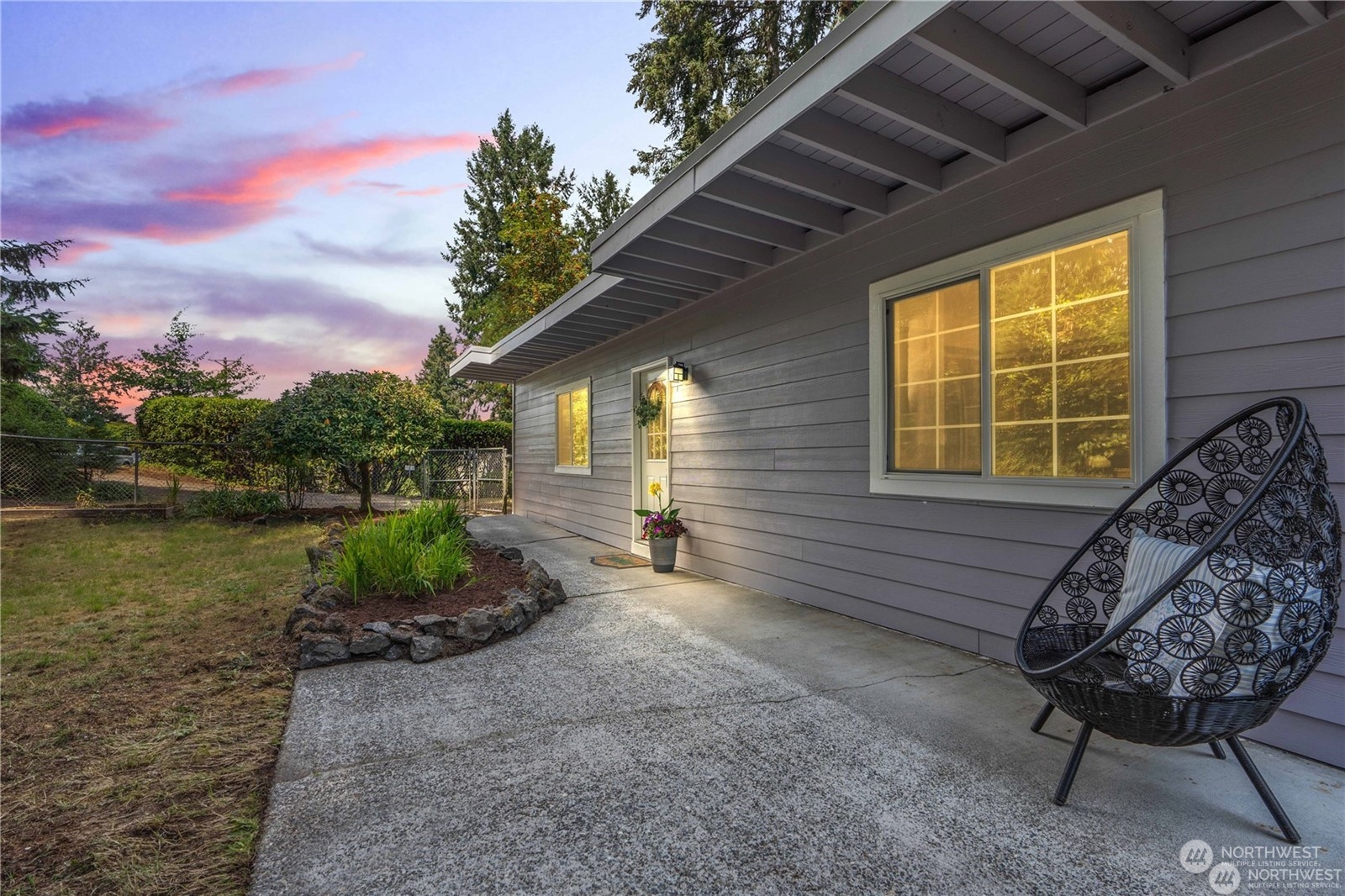 a view of a backyard with sitting area and garden