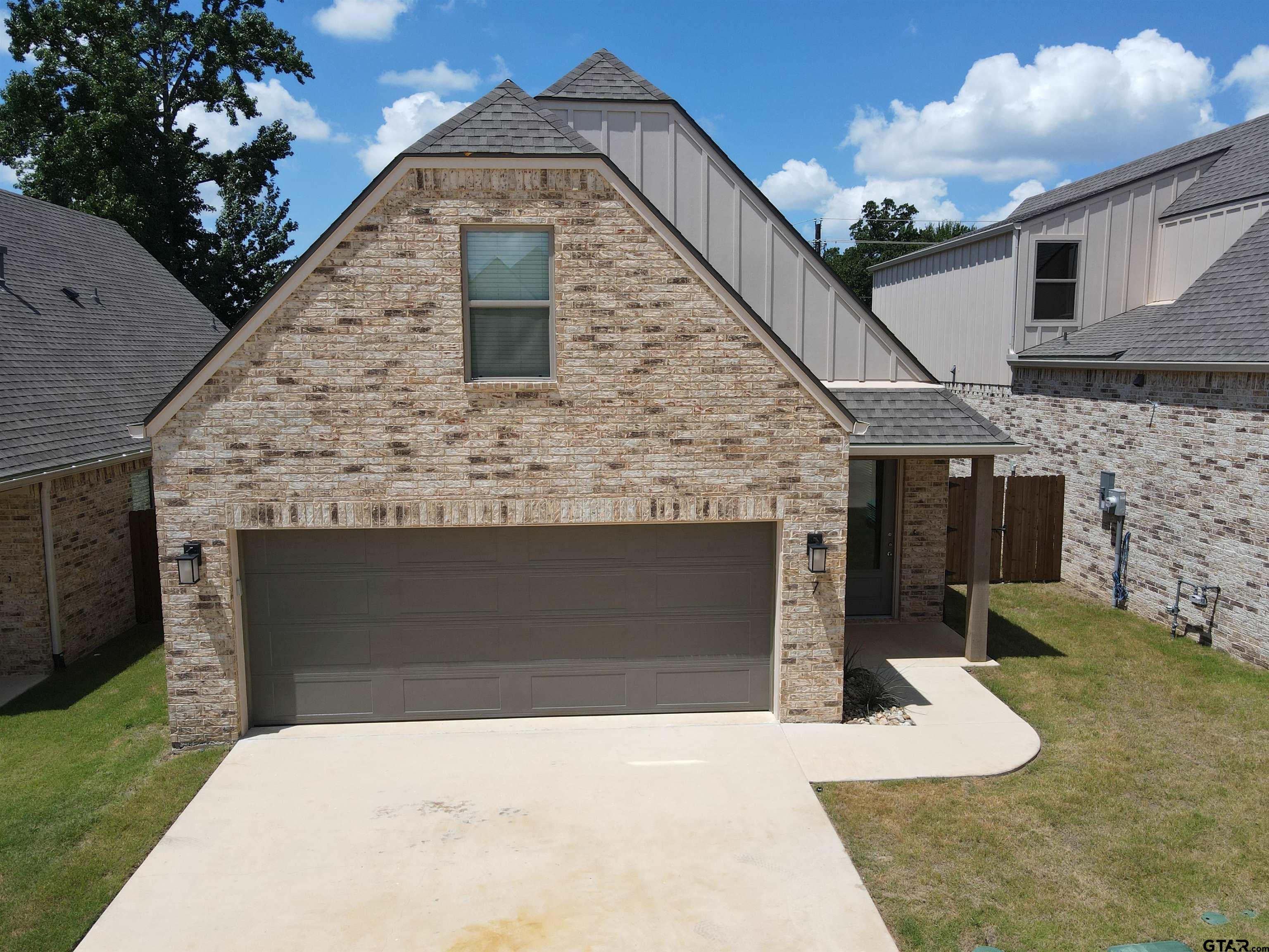 a front view of a house with yard