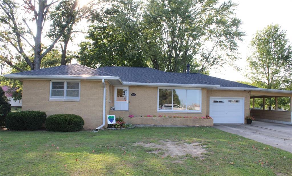 a front view of house with yard and green space