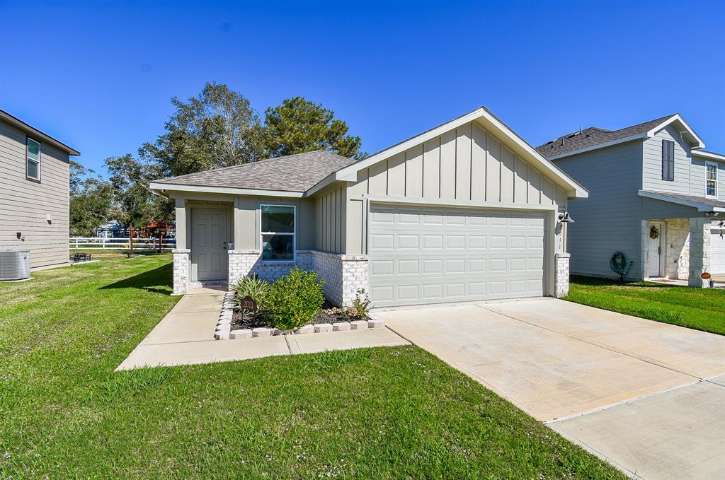 a front view of a house with a yard and garage