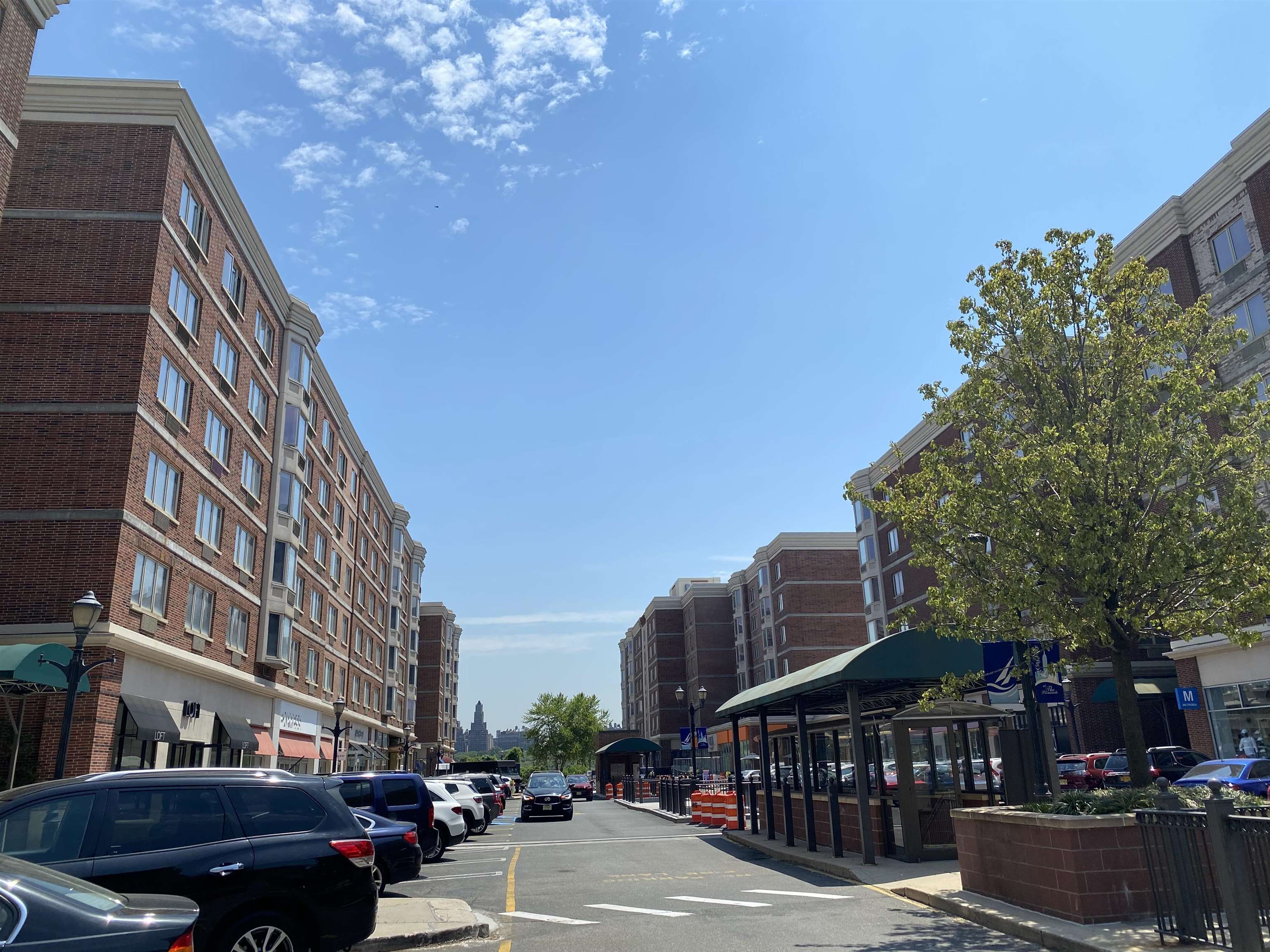 a city street lined with buildings and trees