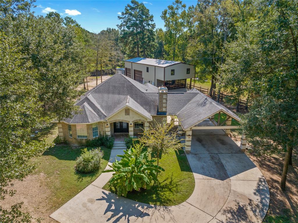 a aerial view of a house with a yard and potted plants