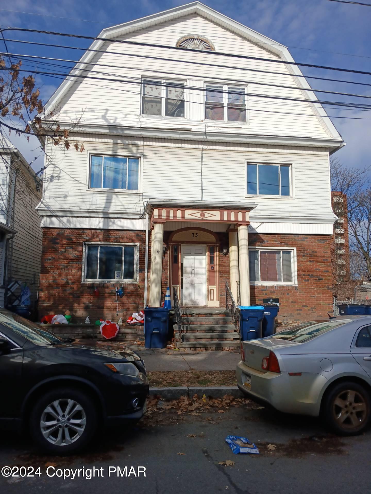 a front view of a house with parking space