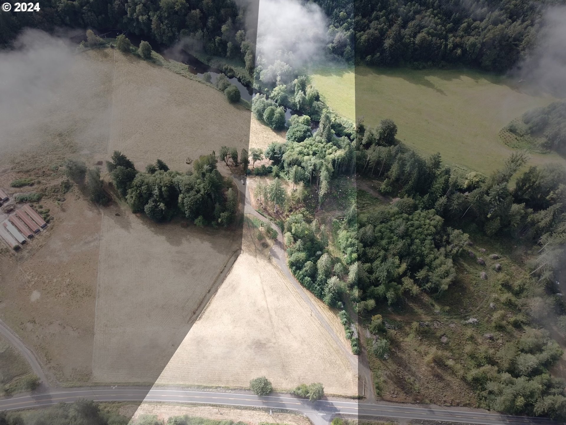 an aerial view of a house with a yard and lake view