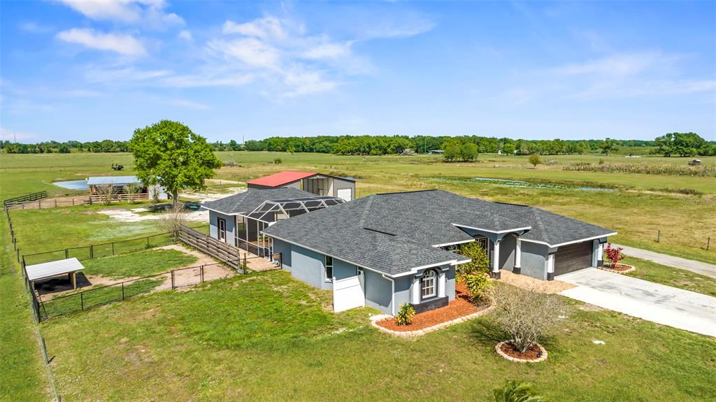 an aerial view of a house with a yard basket ball court and outdoor seating