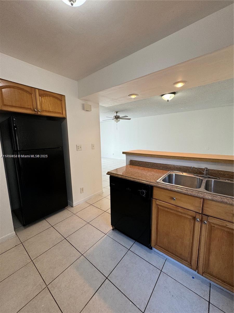 a kitchen with a black white cabinet and a refrigerator