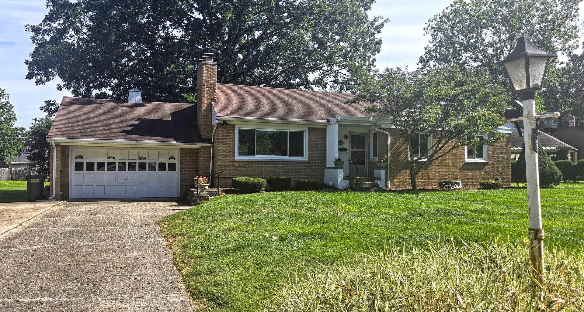 a view of a house with a yard and tree