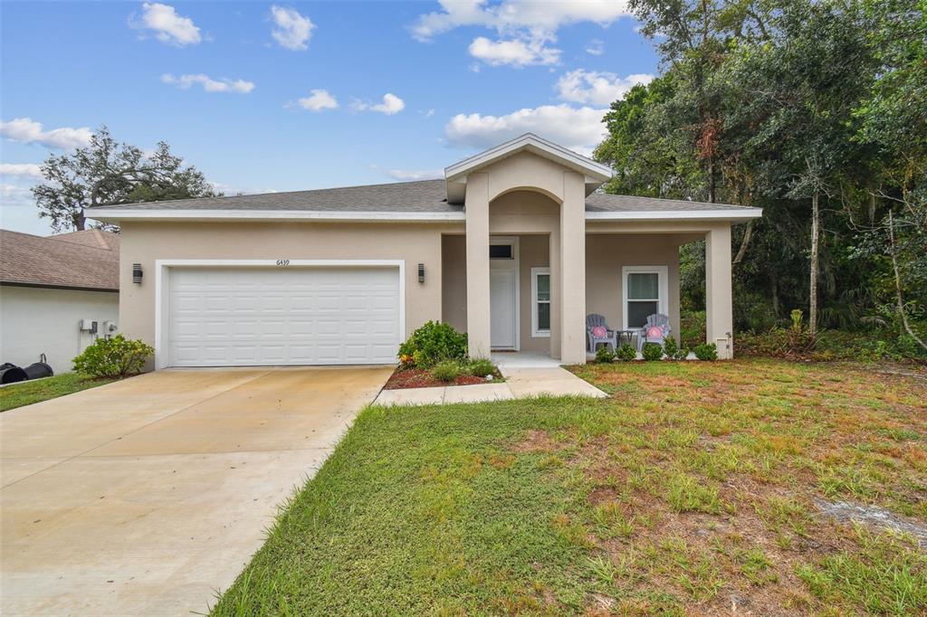 a front view of a house with a yard and garage