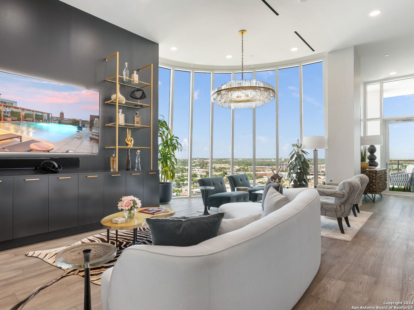 a living room with furniture a chandelier and a table