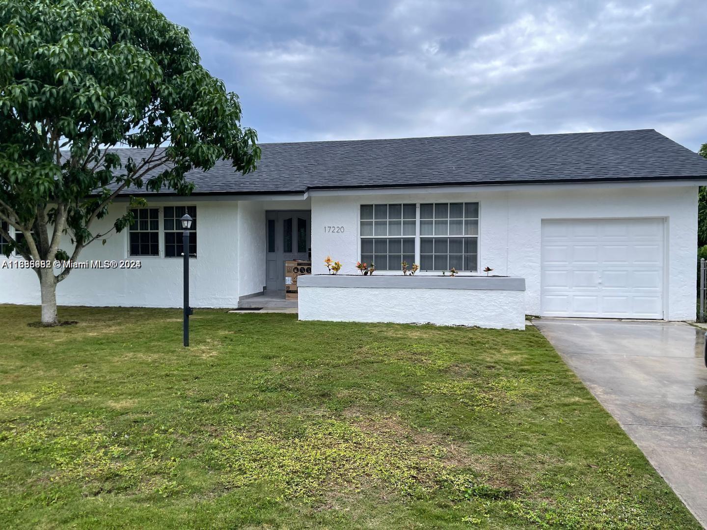 a backyard of house with yard and garage