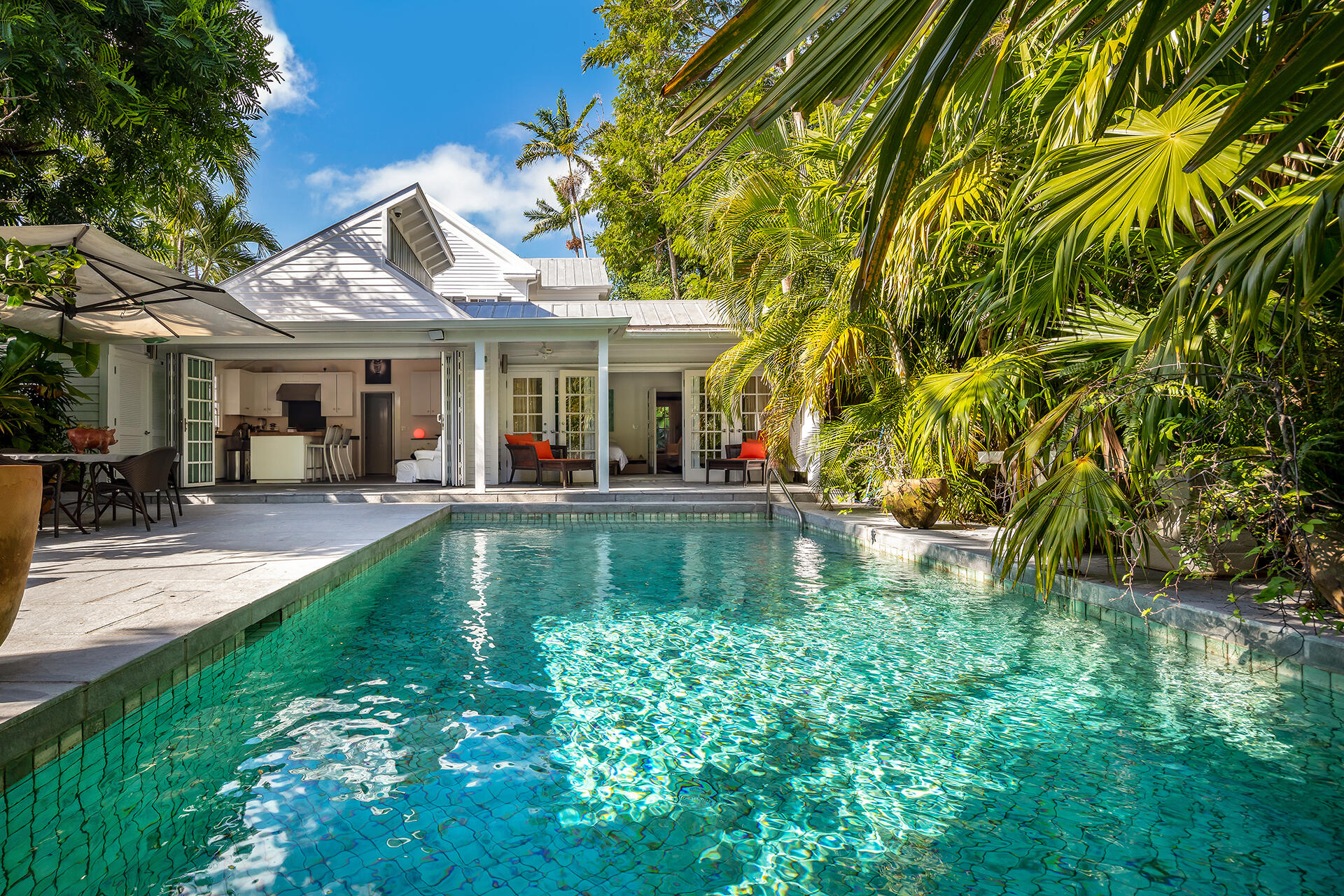 a view of a house with swimming pool and sitting area