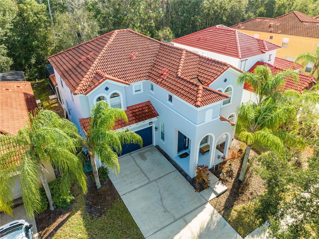 an aerial view of a house with a yard