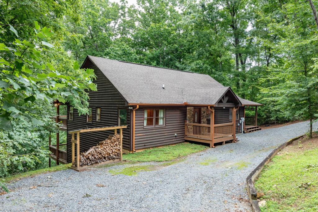 a view of a house with a yard balcony and wooden fence