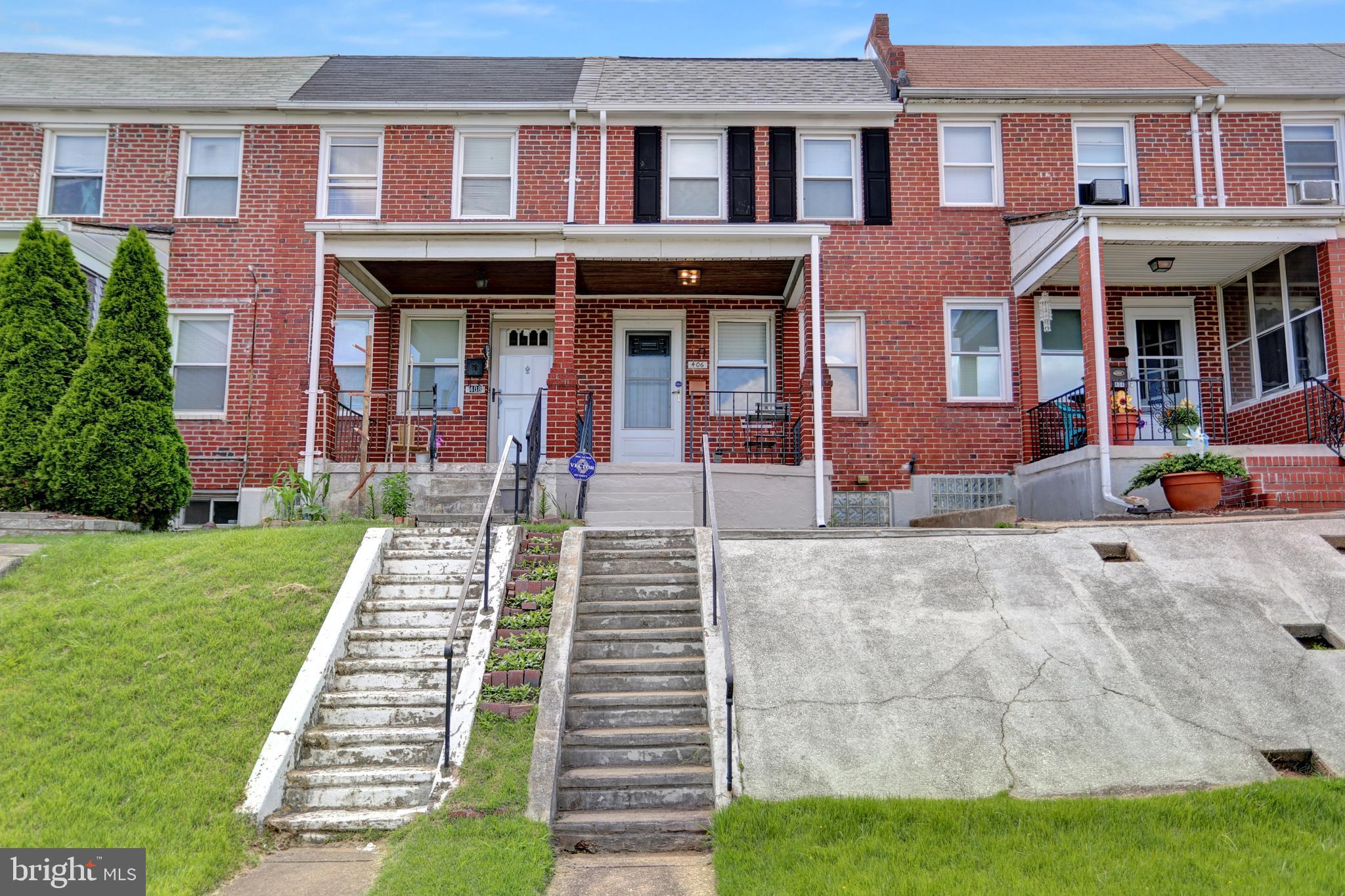 front view of a brick house with a yard